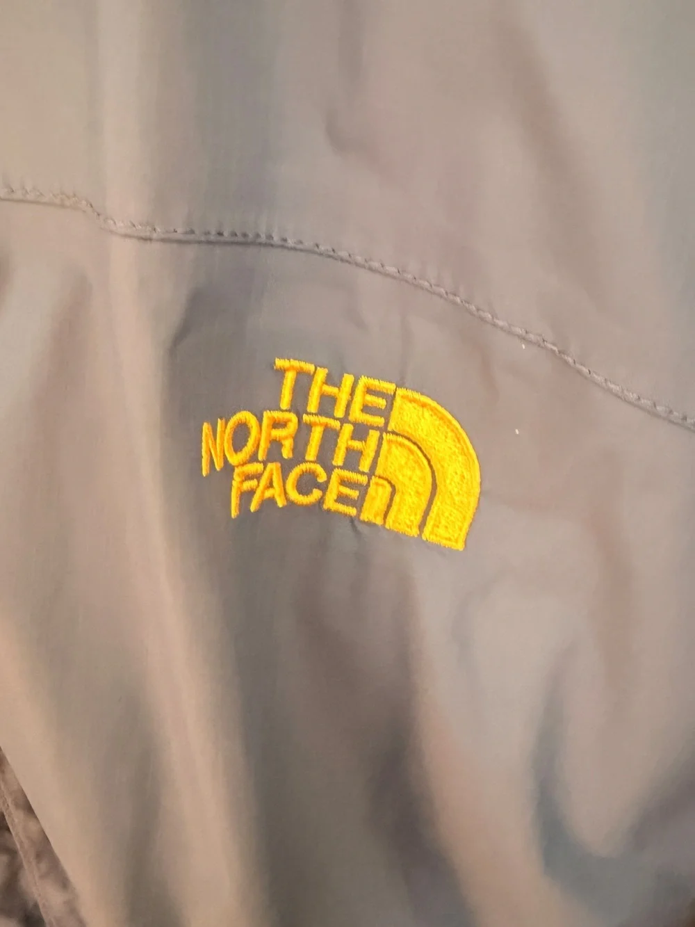 The North Face Men's Blue Rain Jacket with Yellow Hood Lining